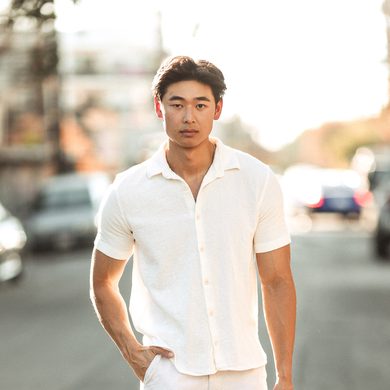 Scott Ho walking down an LA street in an all white outfit at golden hour